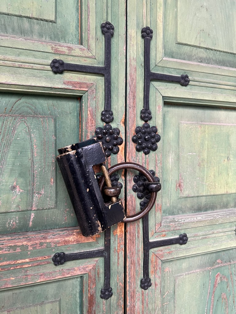 An image of an antique door with lock